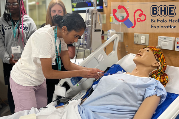 A female student examines a mock patient in the Nursing Lab as part of the Buffalo Health Exploration Program