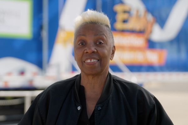 Barbara Glover stands in front of the mobile lung cancer screening unit Eddy.