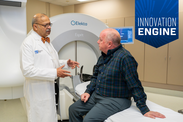 Dr. Dheerendra Prasad speaks with a patient before undergoing gamma knife surgery - banner over photo reads "Innovation Engine"