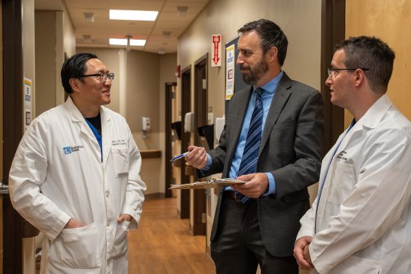 A group of doctors discuss a case