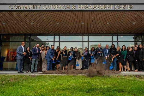 Group of people with shovels break ground on new building