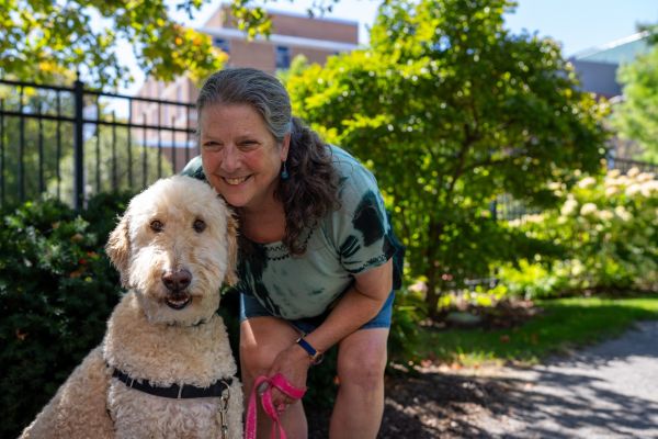 Ovarian cancer survivor Julie Francisco poses with her dog, Morty, in Kaminski Park