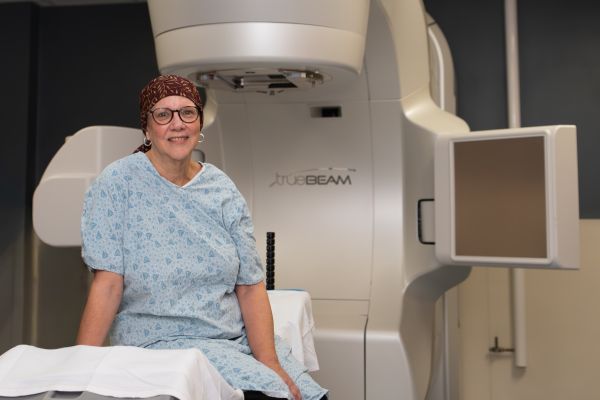 Breast cancer patient and Senior Science Writer Sue Banchich poses for a photo before her radiation treatment