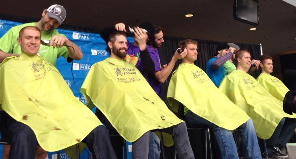 Participants getting their heads shaved at Bald for Bucks