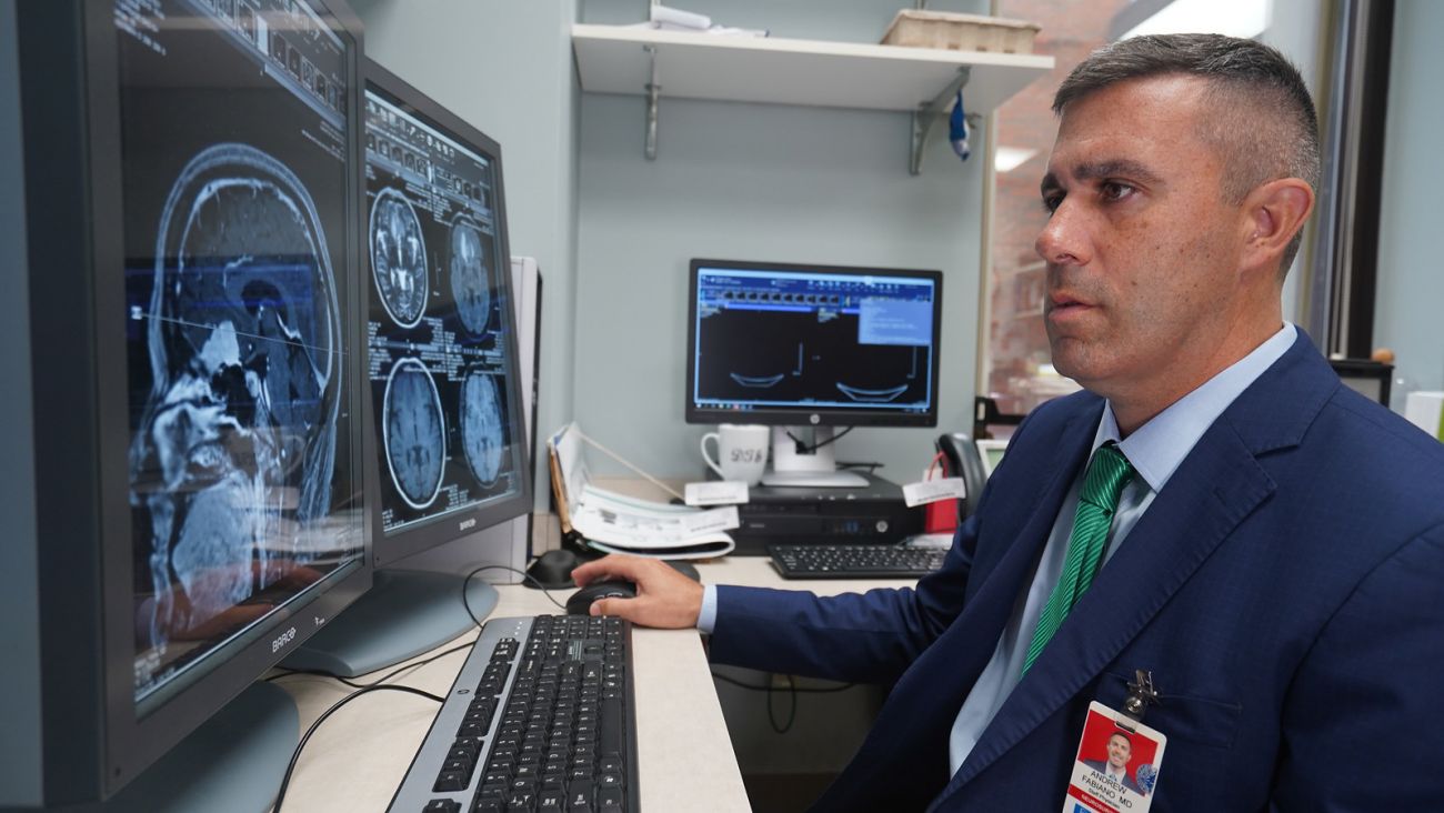 Dr Fabiano looking at brain scans