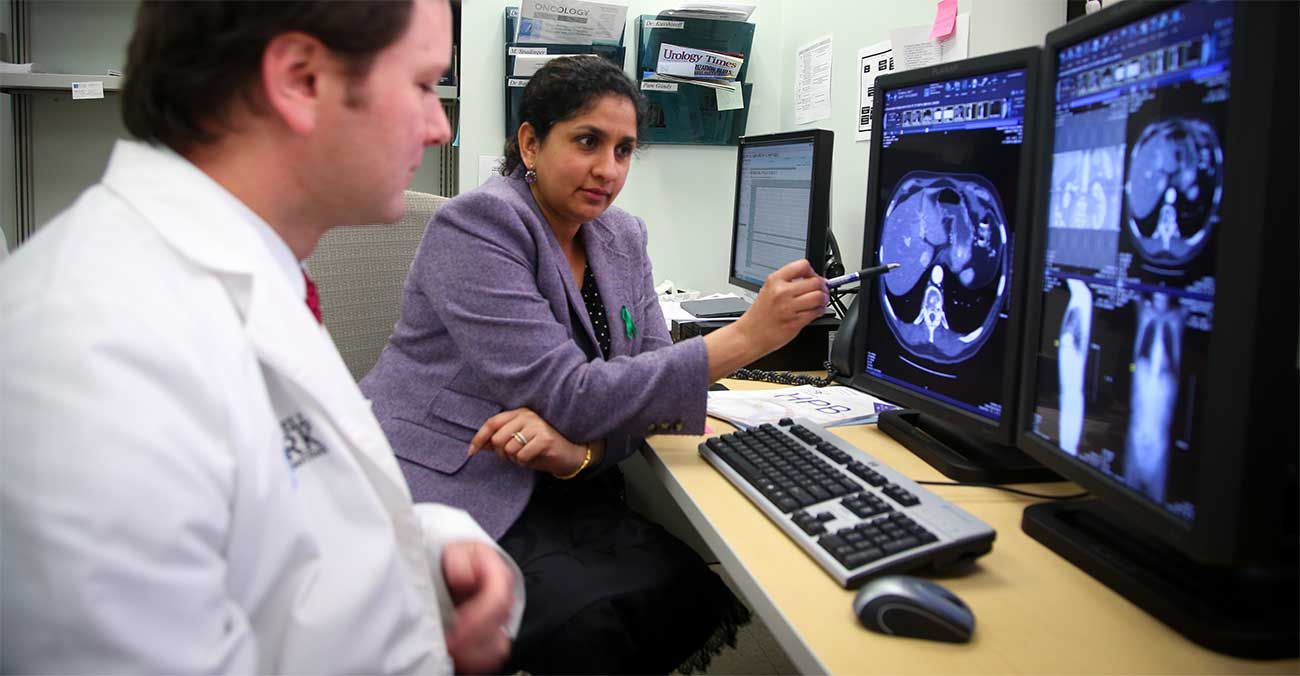 Dr. Iyer reviewing diagnostic scans. 