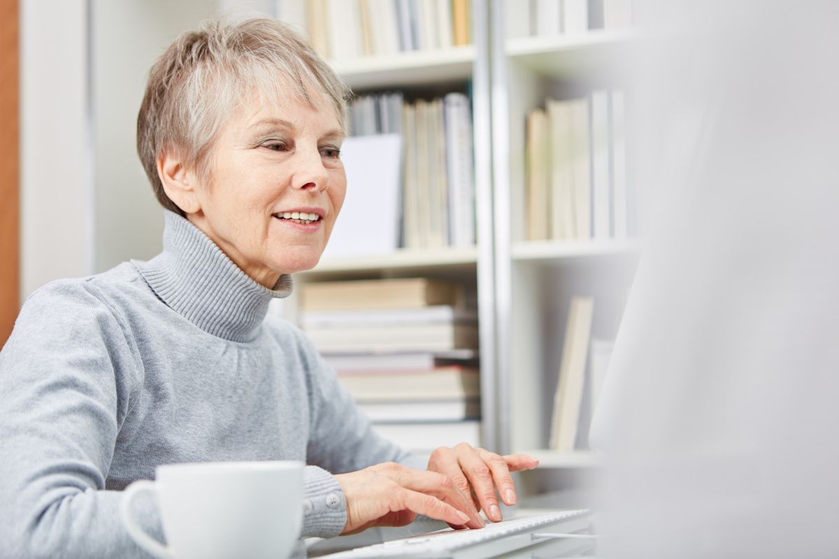 Elderly woman looking at a computer