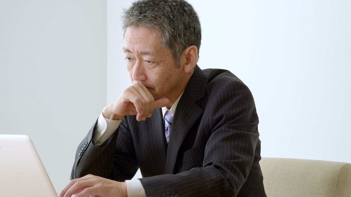 Older man looking at a laptop