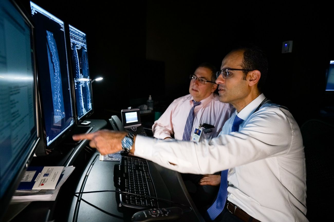 Drs. Ronald Alberico & Ahmed Belal looking at scans.