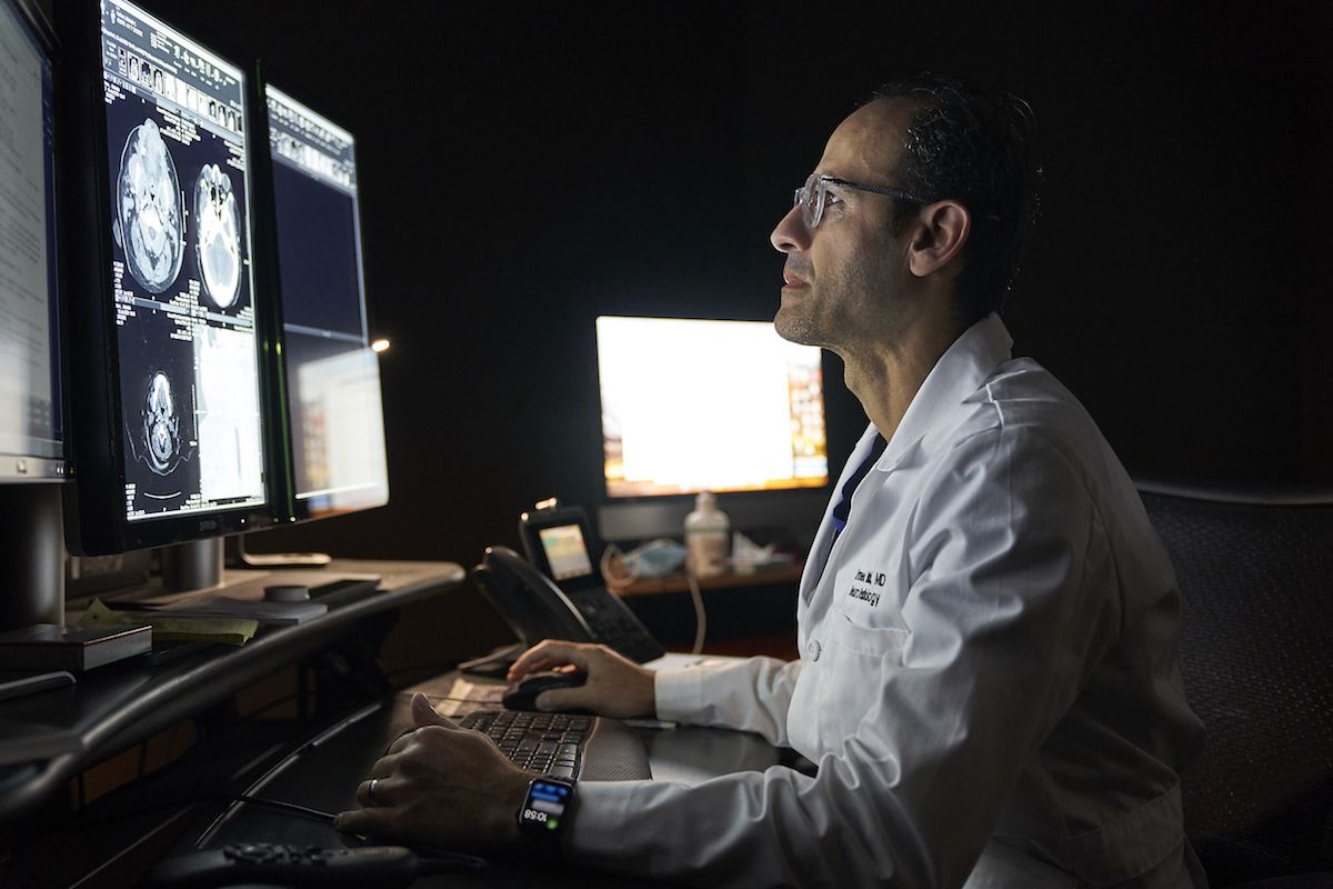 Ahmed Belal, MD diagnosing a brain tumor through imaging.