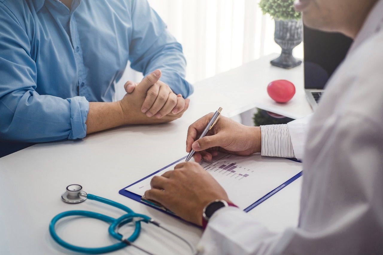 Male patient discussing health with doctor