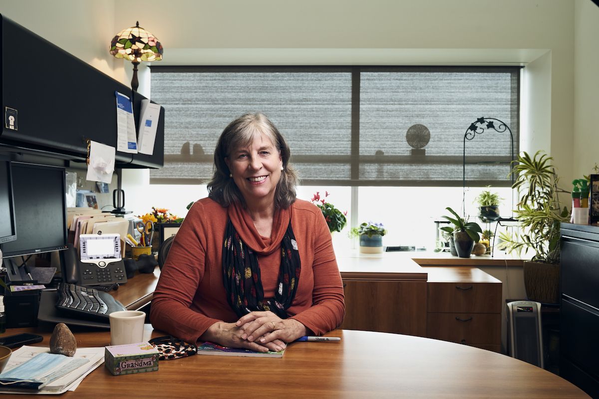 Dr. Elizabeth Repasky sits at her desk in her office.