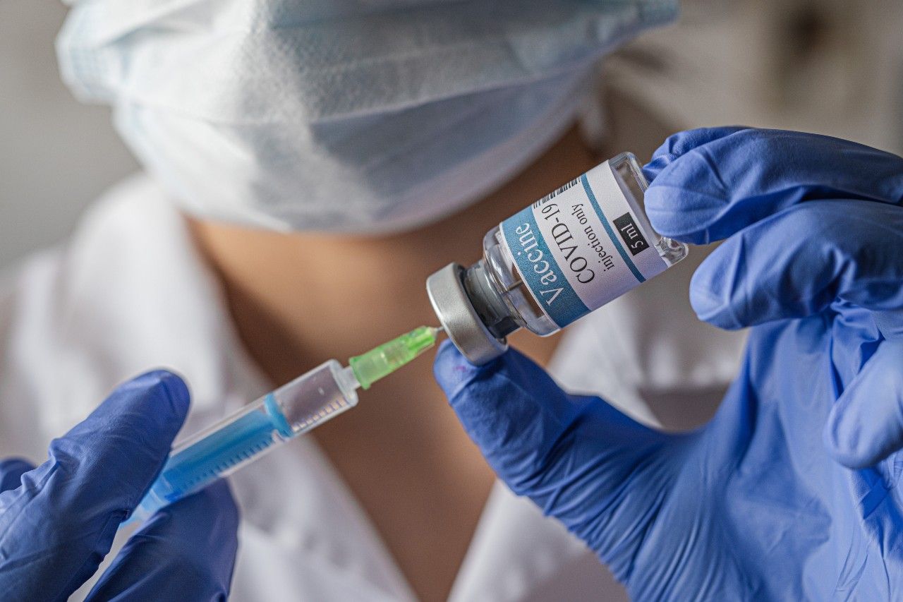 Nurse prepares a COVID vaccine dose. 