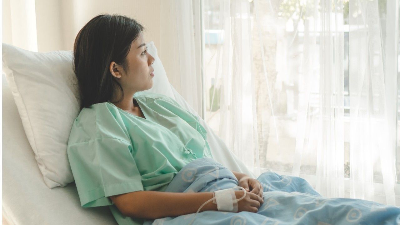 Young adult cancer patient in bed 