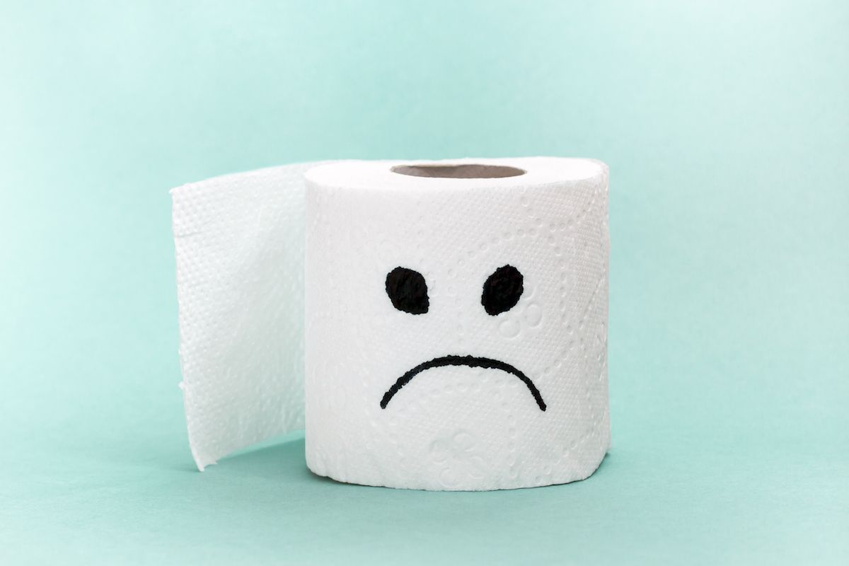 A roll of toilet paper with an unhappy face