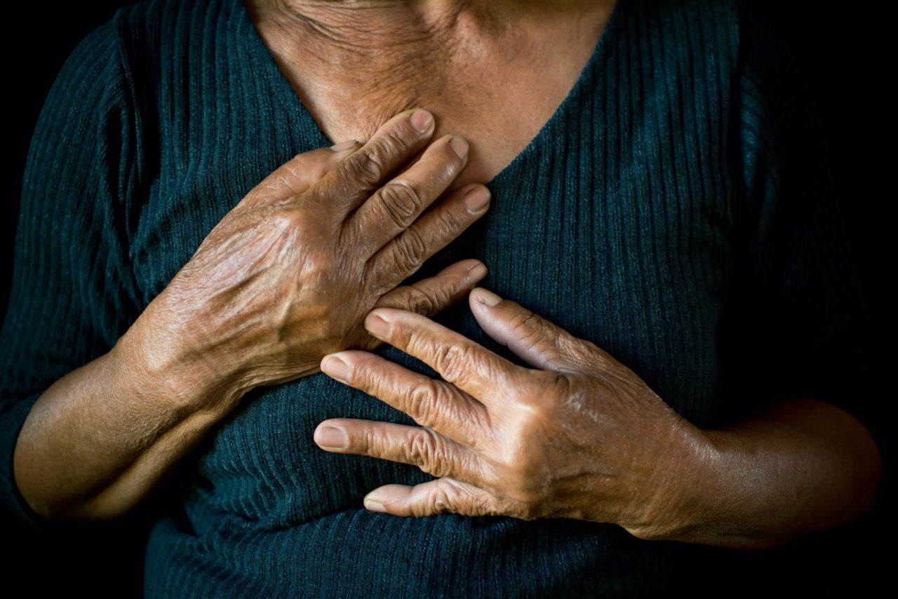 Woman holding her chest