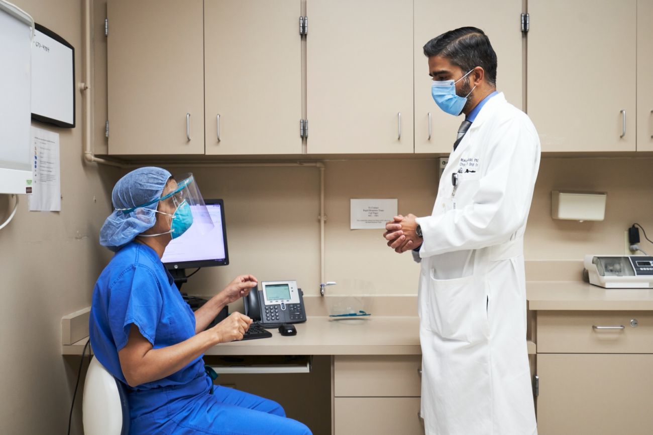 Dr. Seshadri talking with a colleague