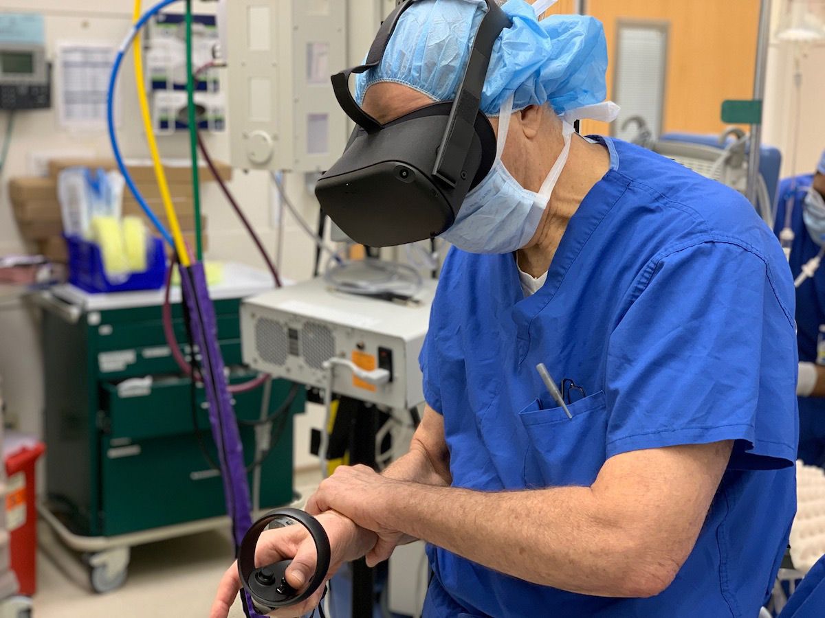 Doctor uses virtual reality goggles and controller to visualize tumor in the operating room before surgery.