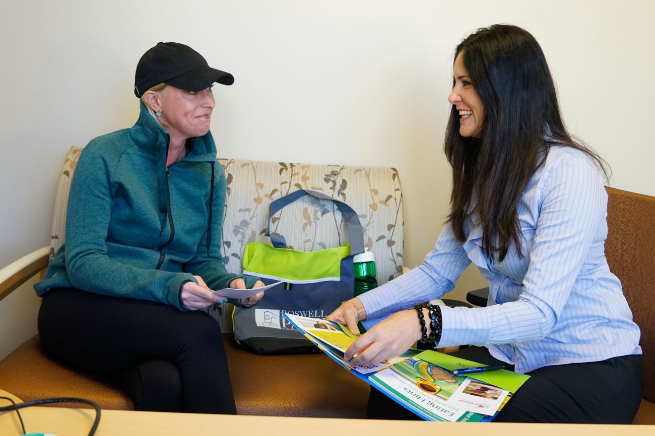 Amy Lesakowski assists a patient with chemotherapy orientation