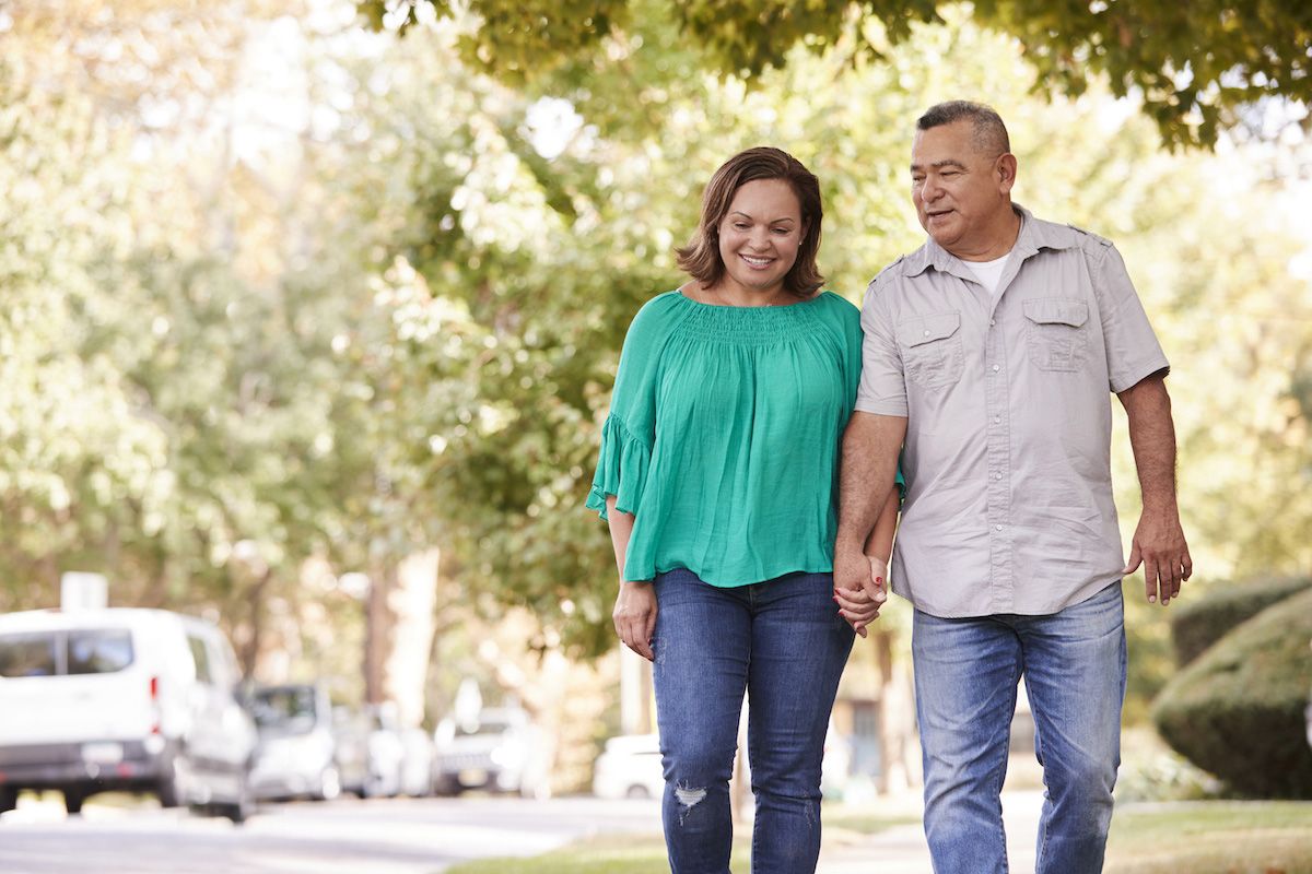 Two middle-aged people walking outdoors for exercise