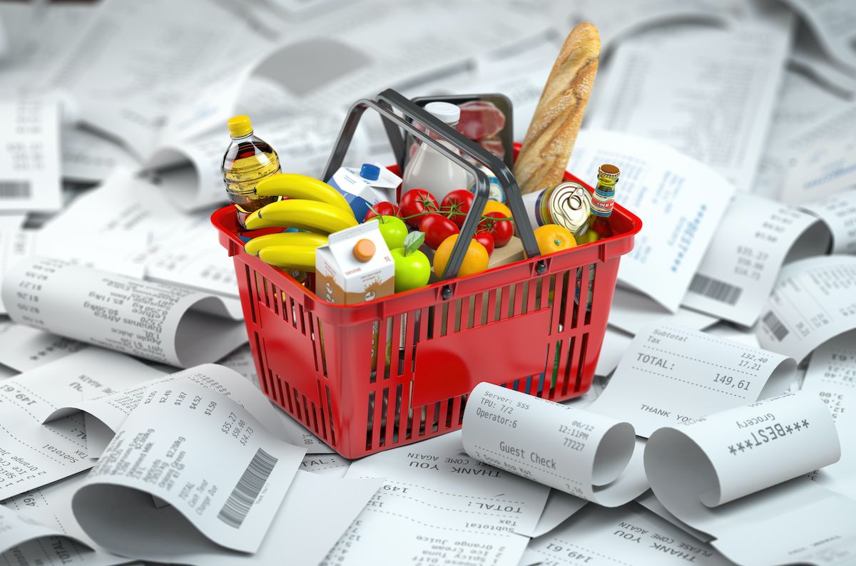 image of food basket on pile of grocery receipts