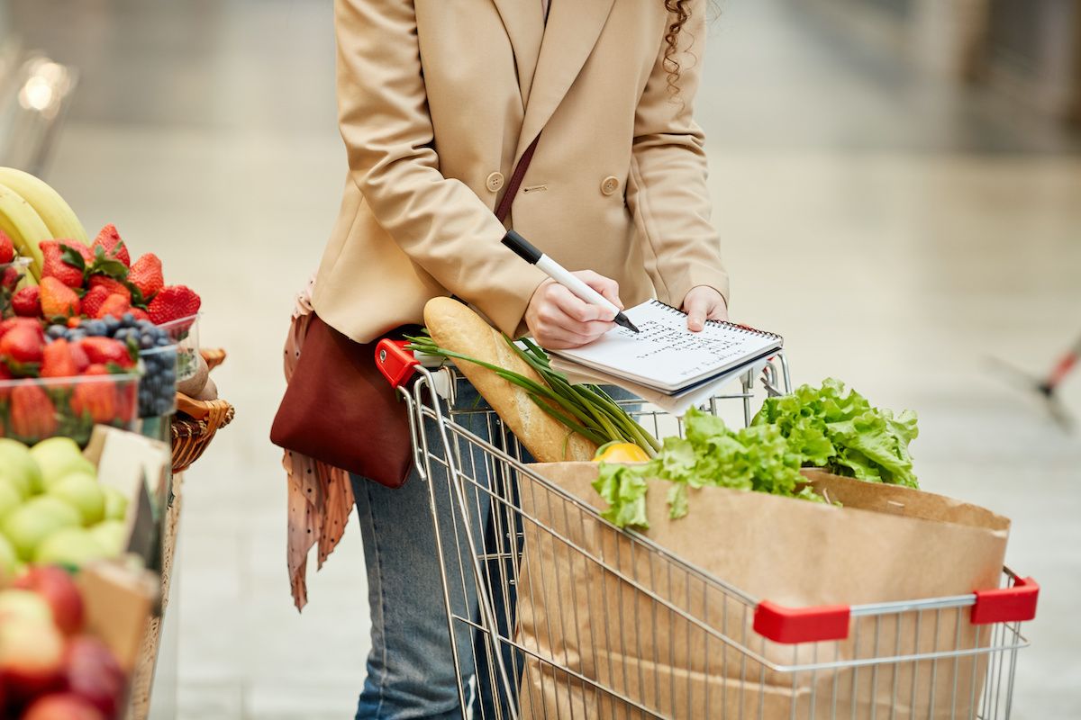 photo of woman in grocery store with a notbook