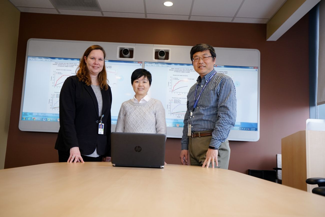 three doctors stand behind a table