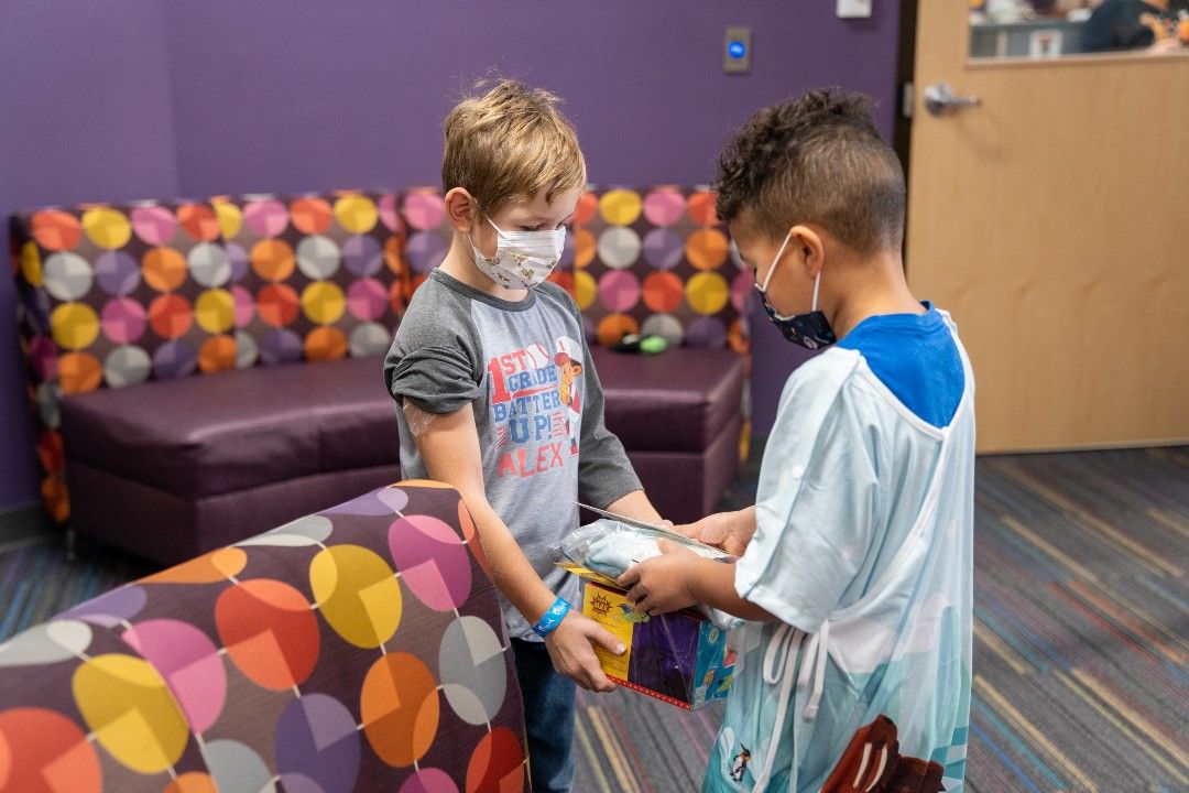 Andre 'The Warrior' Sanders gives his friend Alex a special hospital gown Andre designed, along with a pair of grippy socks and a turtle nightlight.