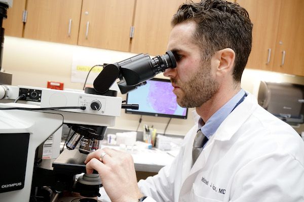 Dr. Michael Bax looks through a magniscope 