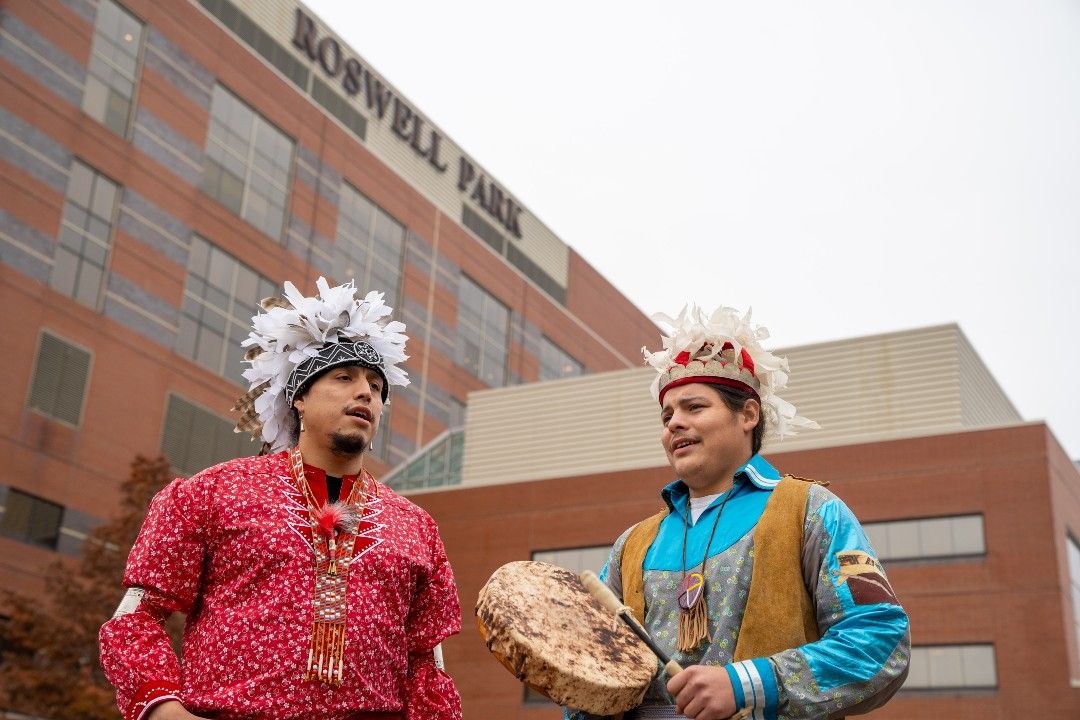 Gehnew Printup and Tosh Hamby , performers from the Tuscarora Nation, sang a traditional song  in Kaminski Park in commemoration of Native American Heritage Month.