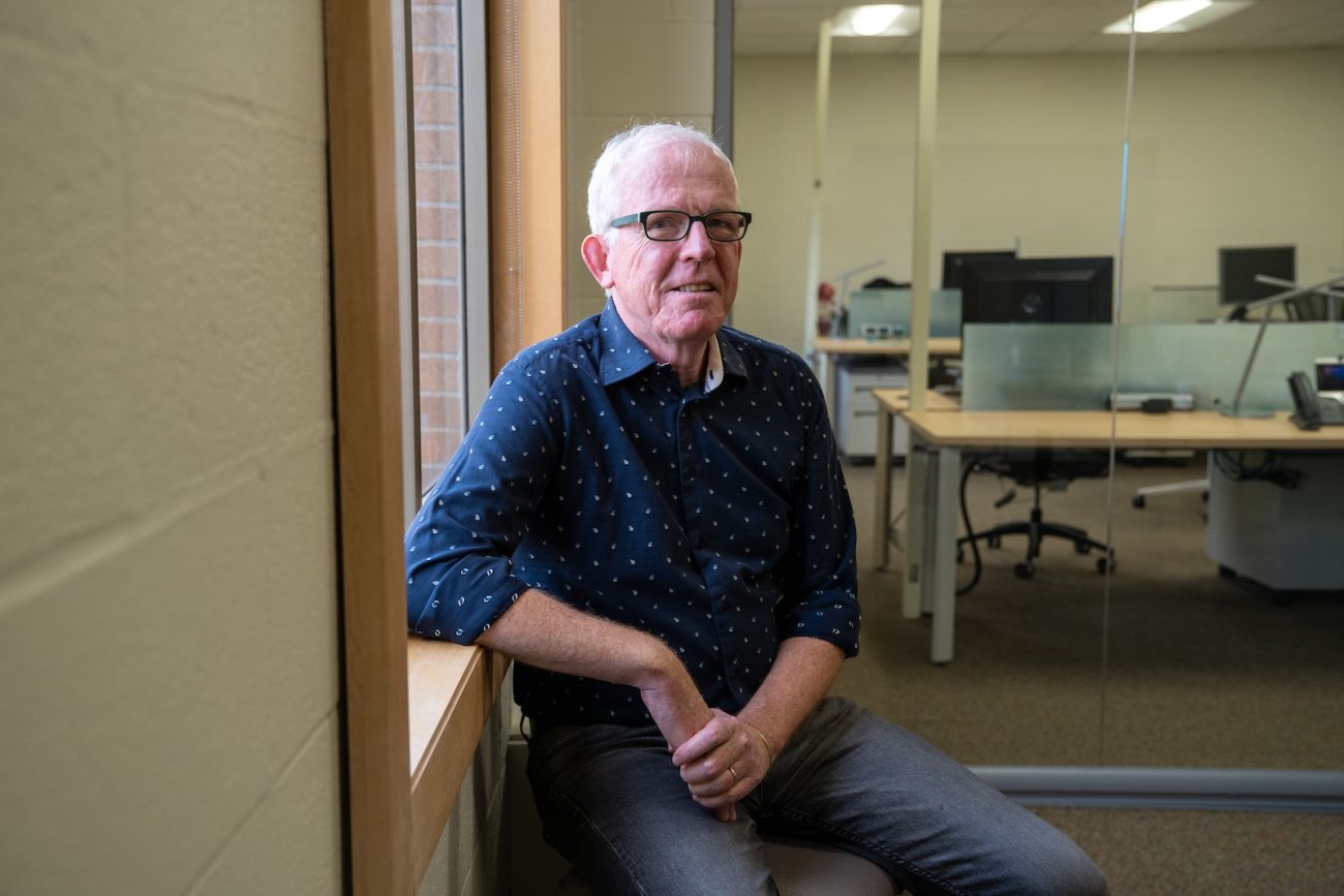 Dr. Martin Morgan sits in his office.