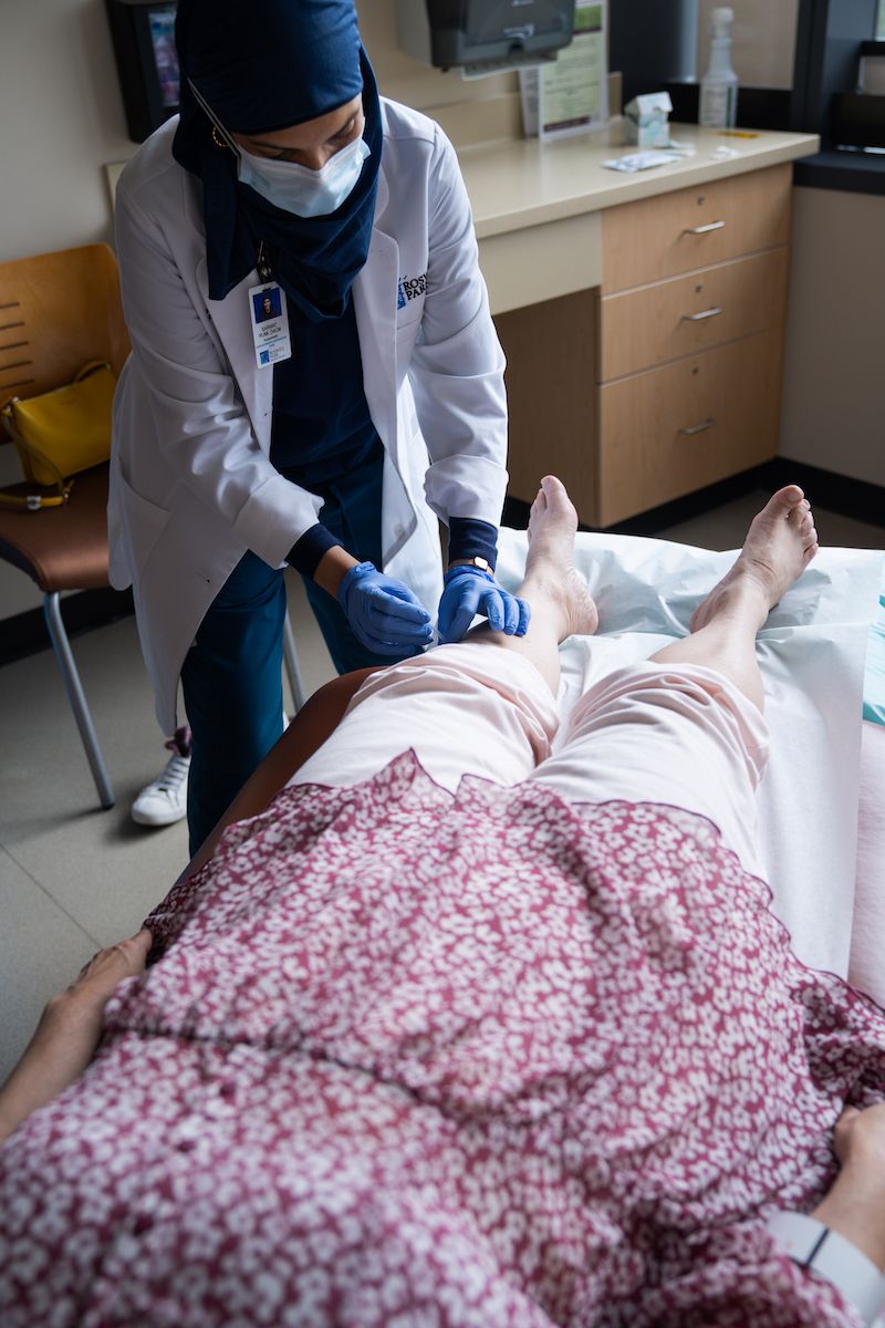 Dr. Rumi using acupuncture on a cancer patient