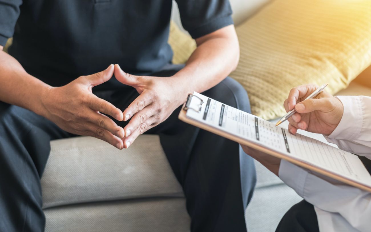 Man sitting with doctor having a consultation