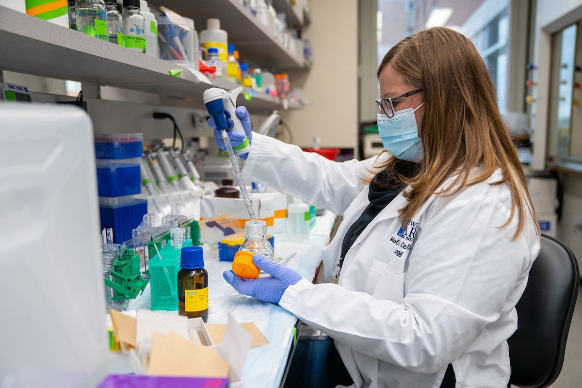 Scientist using a pipette