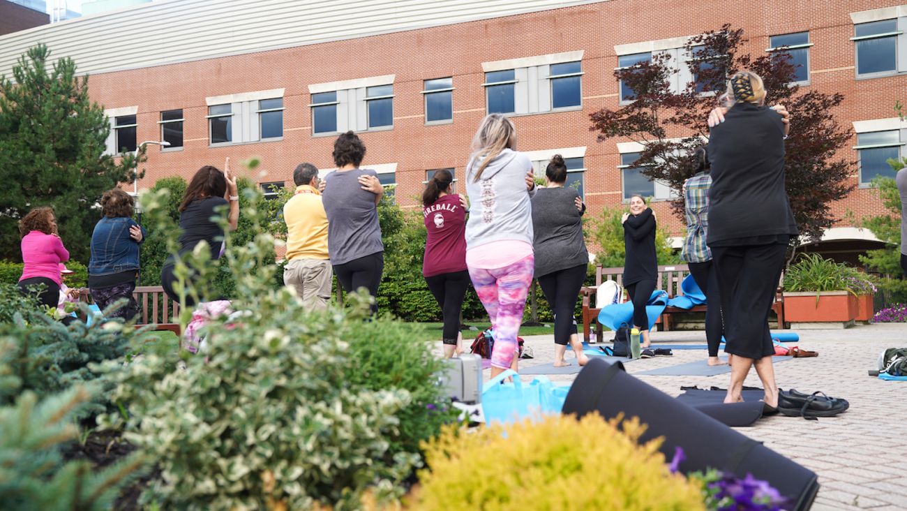 Dr. Kate Glaser leads a yoga session in the park at the Chapter 2 Cancer Survivorship Workshop 2019