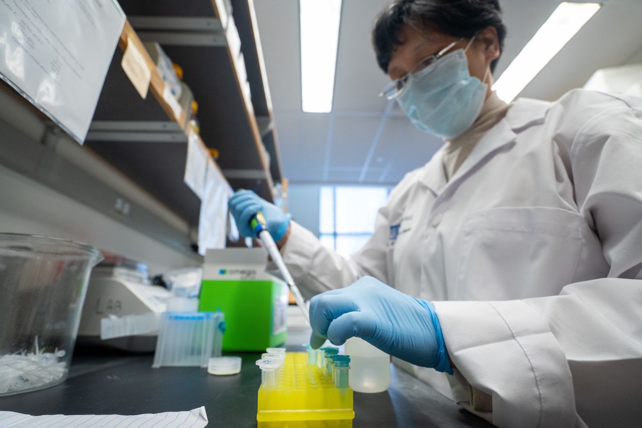 Scientist filling a test tube