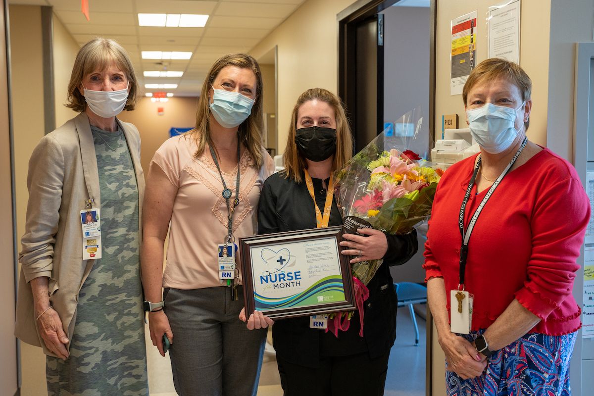 Michelle Kraska, second from left, holds a certificate naming her Nurse of the Month for June. 