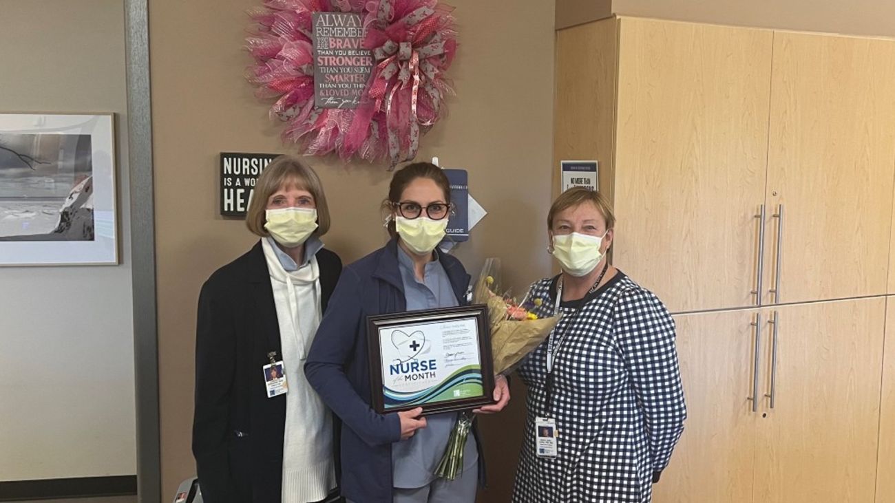 Shelby Max, center, holds a plaque presented to her from Dr. Candace Johnson, left, and Mary Anne Long, right.