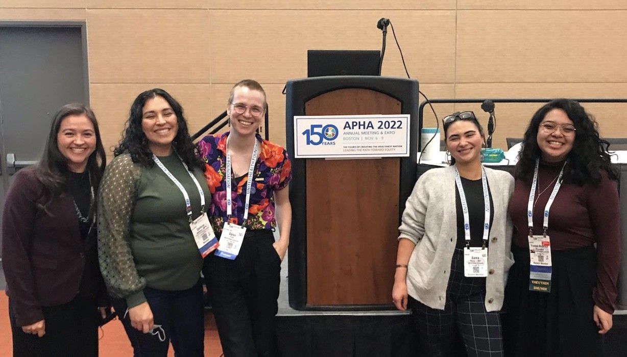 Josie Raphaelito, left, stands with other women in a conference room during the American Public Health Association Conference in Boston. 