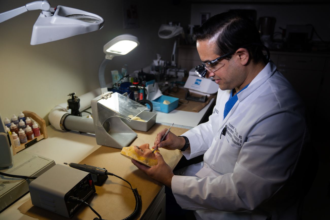 Dr. Frias working on prosthetics in lab April 2021