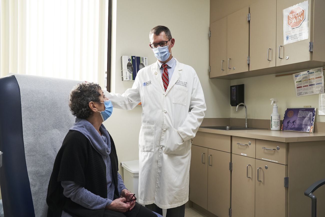 Dr. John Kane consults with a patient in the melanoma clinic