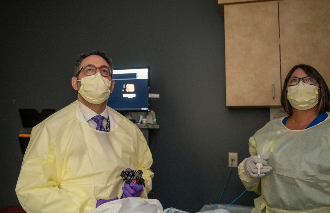 Dr. Anthony Dakwar in clinic performing a colonoscopy with a PA standing by