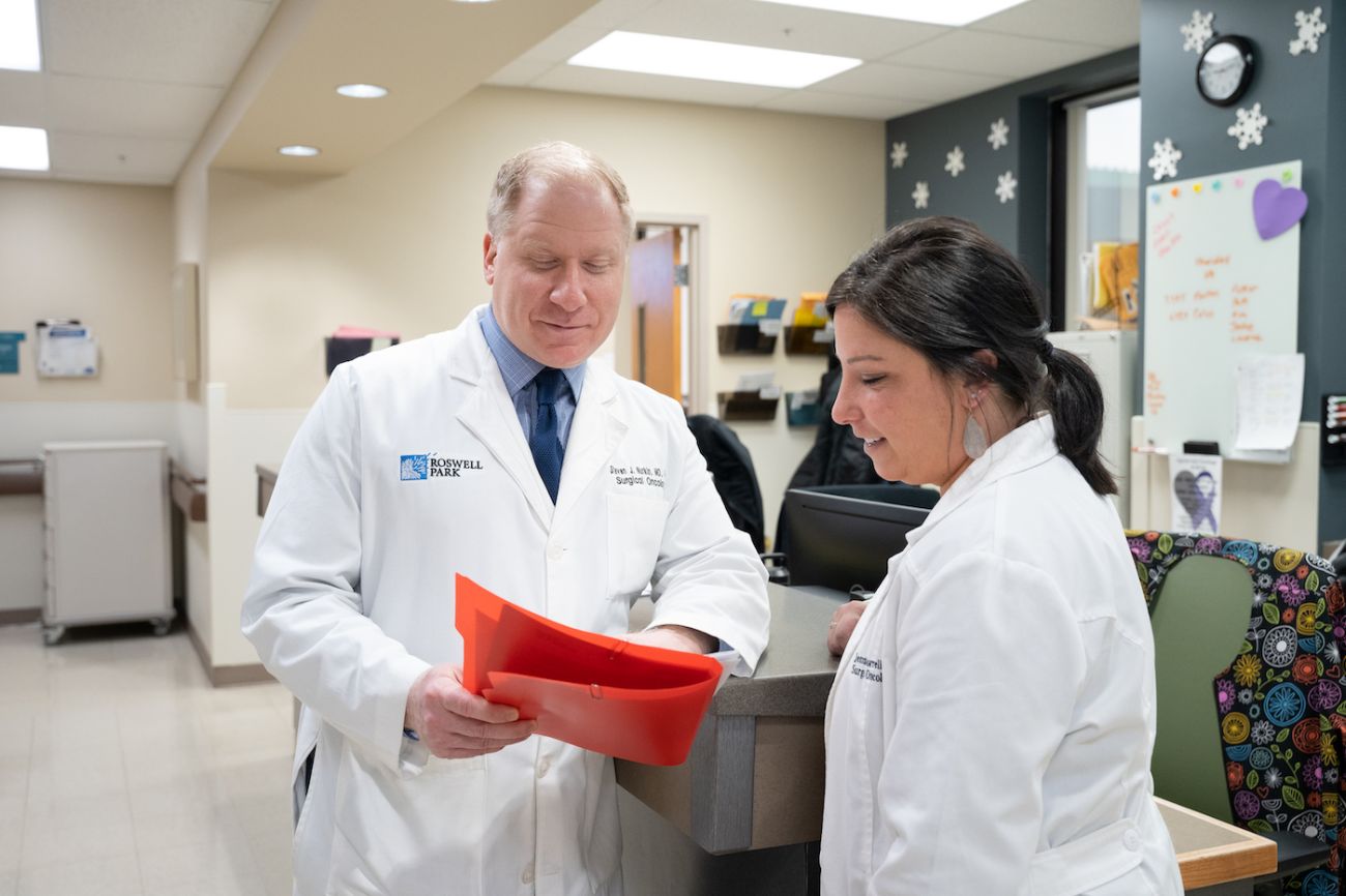 Dr. Steven Nurkin interacts with a colleague in clinic