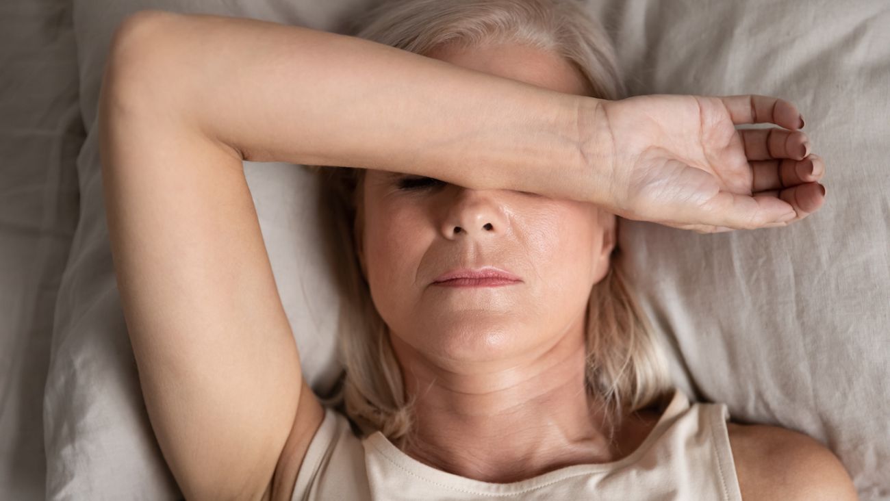 Woman in bed not feeling well