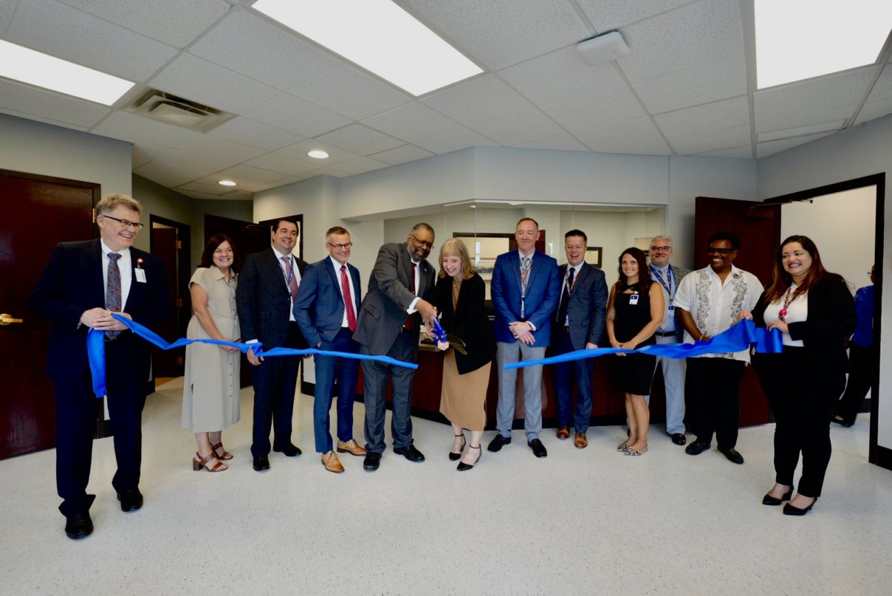 Many people line up to cut a ribbon