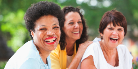 Three women smiling and laughing