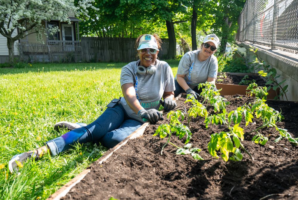 Employees planting a garden for the community
