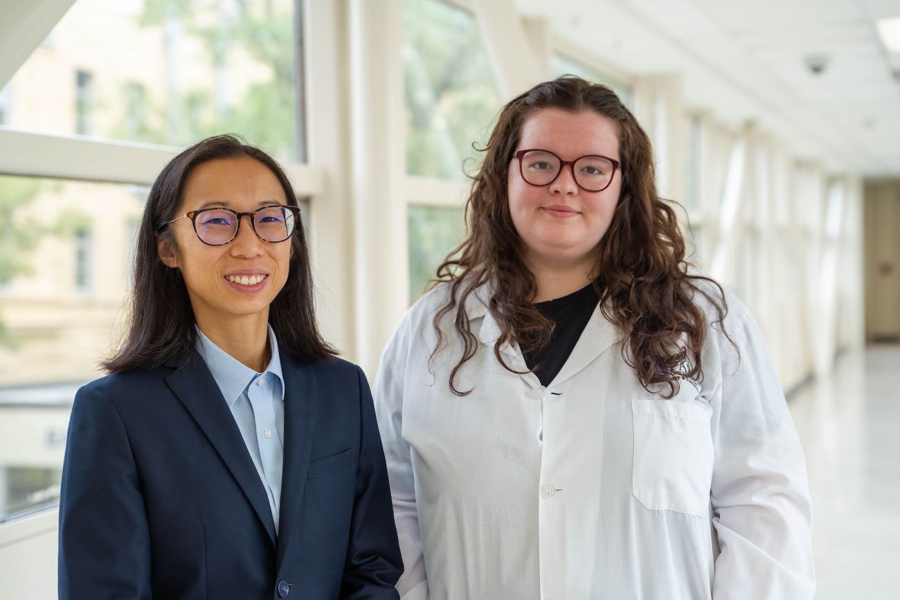 Two cancer researchers standing in a hallway