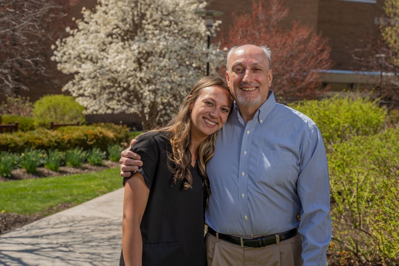 John stands outside Roswell Park with his arm around his daughter, Lydia.