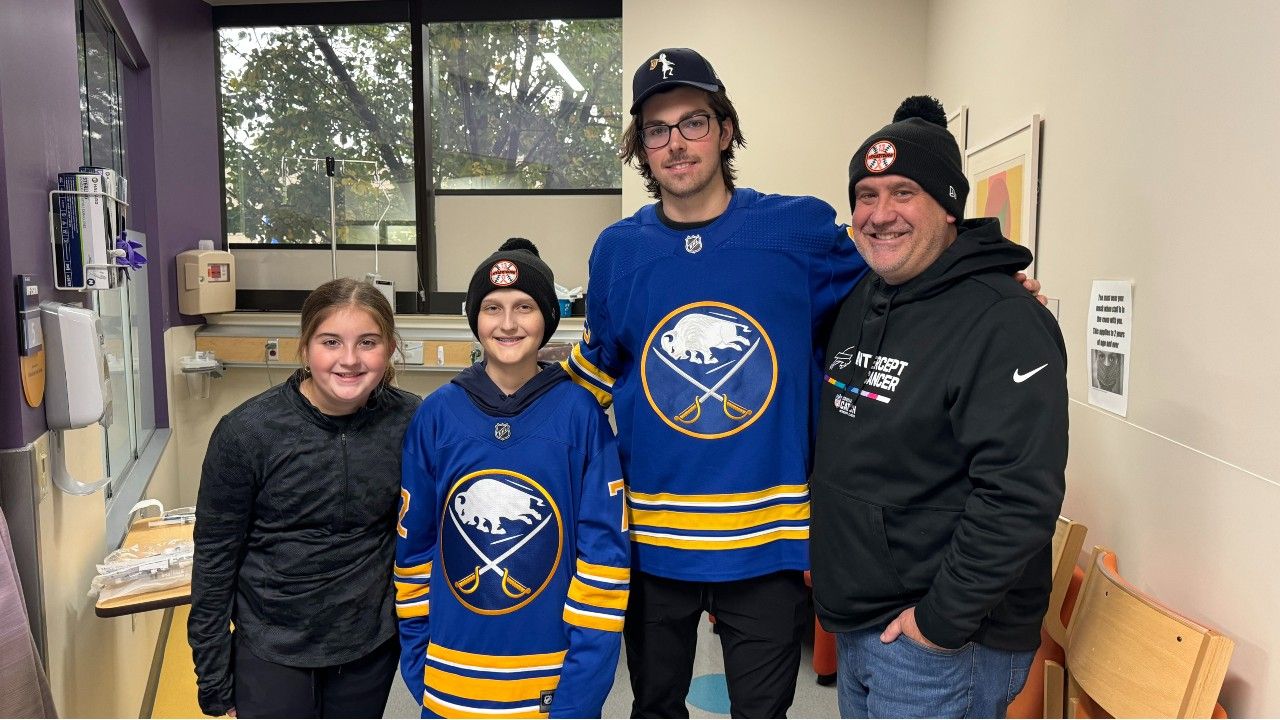 Tyler Kruse, second from left, stands with his sister, Taylor, Buffalo Sabres defenseman Owen Power, and father Mike Kruse. 